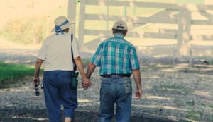 older adult couple walking happily together, holding hands